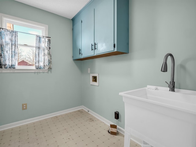 clothes washing area featuring light floors, baseboards, cabinet space, a sink, and washer hookup