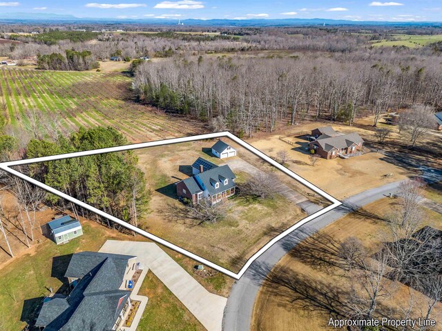 birds eye view of property with a rural view