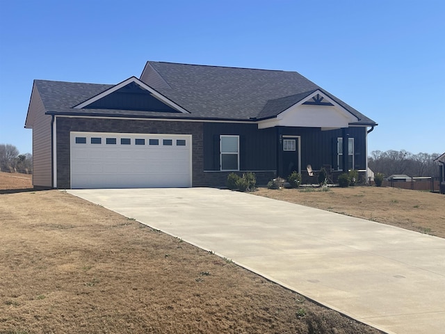 view of front of home featuring a garage, board and batten siding, concrete driveway, and a shingled roof