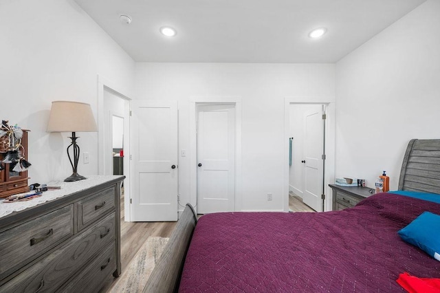 bedroom with recessed lighting and light wood-type flooring