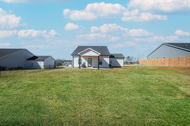 exterior space featuring a front lawn and fence