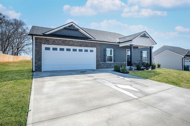 view of front of home with stone siding, board and batten siding, an attached garage, and a front lawn