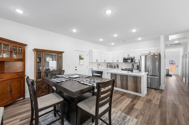 dining space featuring recessed lighting, wood finished floors, and visible vents