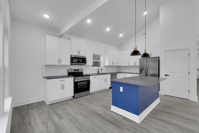 kitchen with a sink, a center island, stainless steel appliances, white cabinets, and light wood finished floors