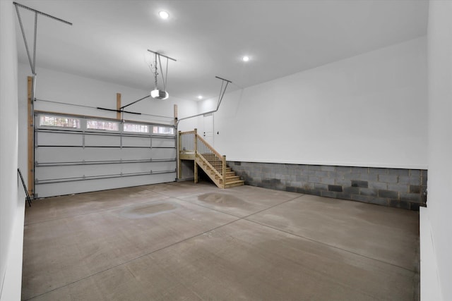 garage with recessed lighting and a garage door opener