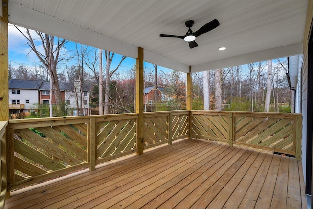 wooden terrace featuring a residential view and ceiling fan