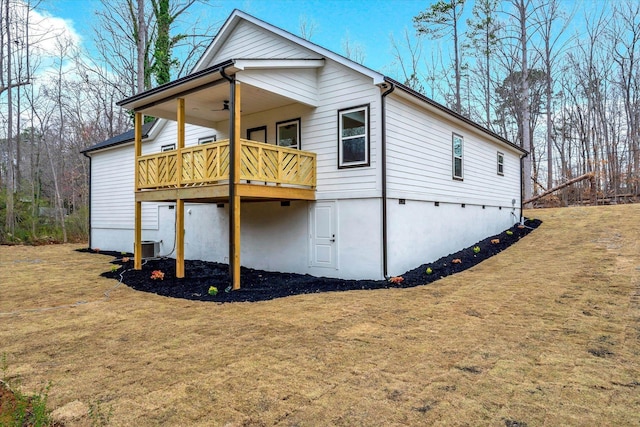 exterior space with a deck, central AC unit, ceiling fan, and a front yard