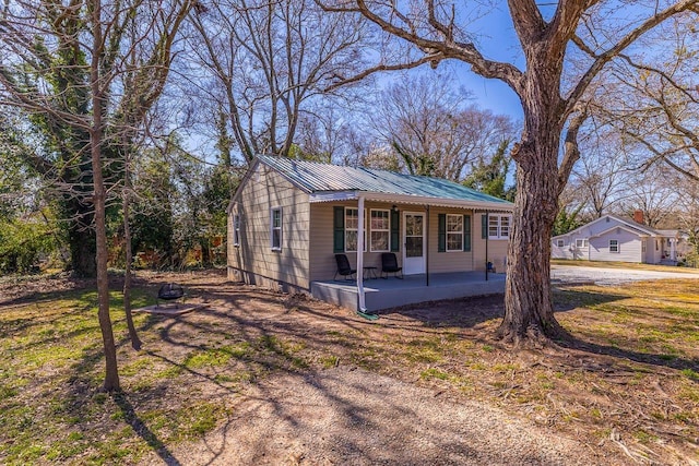 view of front of property featuring covered porch and metal roof