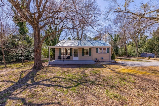 view of front of house featuring a porch and metal roof