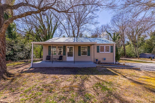 view of front of home featuring metal roof and covered porch