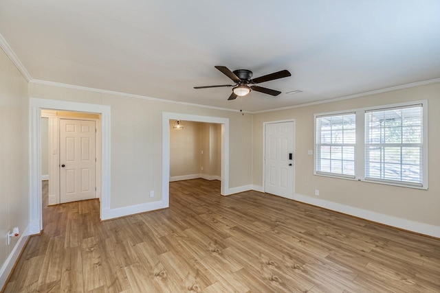 interior space with a ceiling fan, crown molding, light wood-style floors, and baseboards