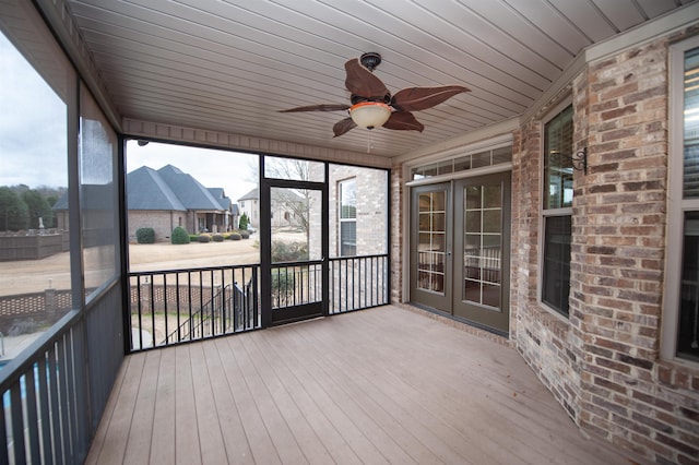 unfurnished sunroom featuring a ceiling fan and wood ceiling