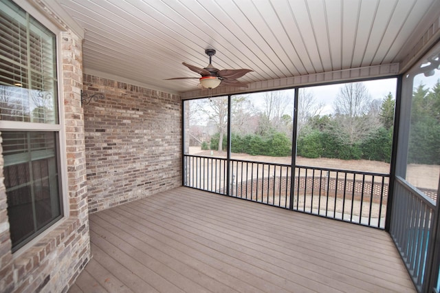 unfurnished sunroom with ceiling fan and wooden ceiling