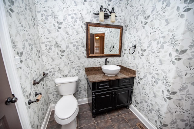 bathroom with vanity, baseboards, wallpapered walls, tile patterned floors, and toilet