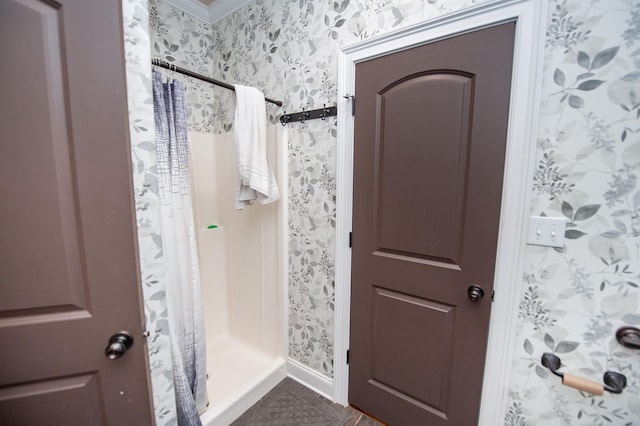 full bathroom with tile patterned flooring, baseboards, a shower stall, and wallpapered walls