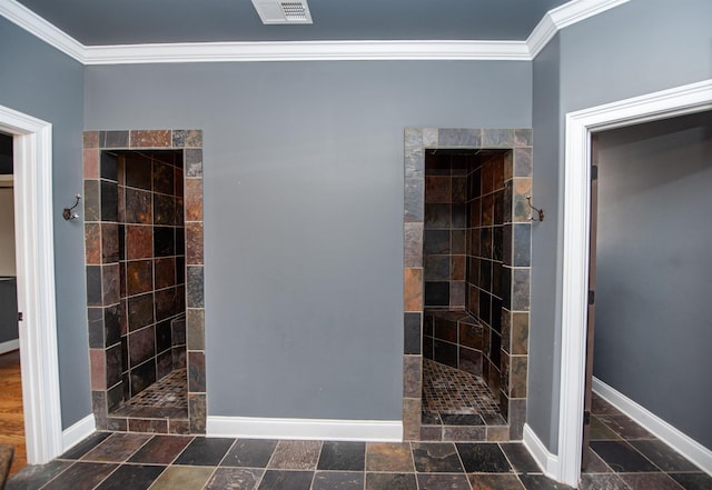 bathroom featuring crown molding, visible vents, baseboards, and walk in shower