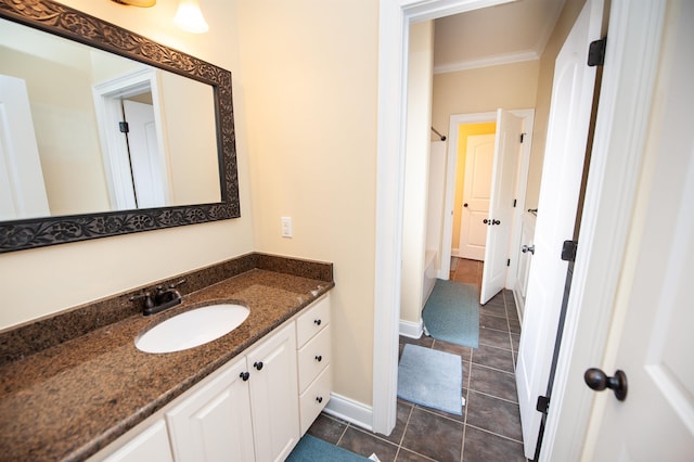 bathroom with tile patterned flooring, baseboards, shower / bath combo with shower curtain, ornamental molding, and vanity