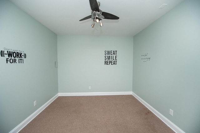 carpeted empty room featuring baseboards and ceiling fan