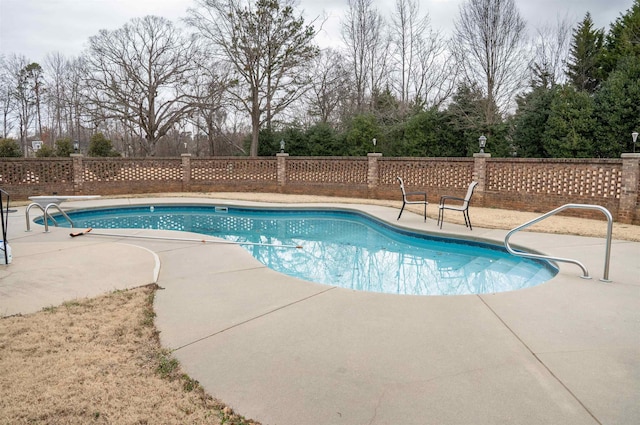 view of pool with a fenced in pool, a patio, and fence