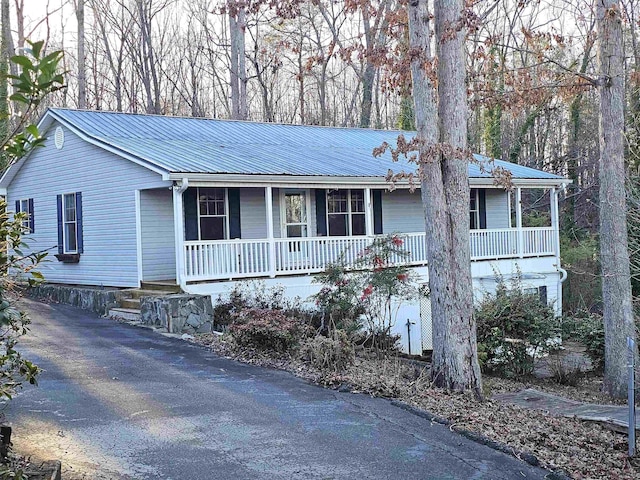 view of front of house with metal roof and a porch