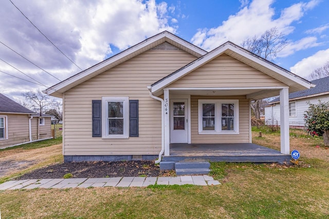 bungalow-style house featuring a front yard