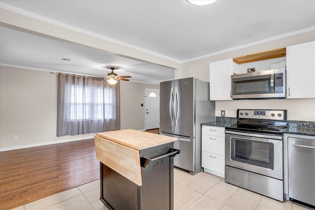 kitchen featuring a ceiling fan, stainless steel appliances, light wood-style floors, white cabinets, and crown molding