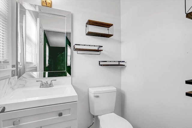 bathroom featuring toilet and vanity