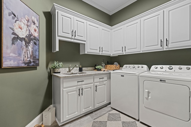 laundry area with independent washer and dryer, a sink, cabinet space, crown molding, and baseboards