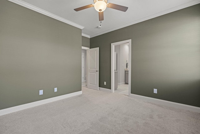 spare room featuring baseboards, light carpet, ornamental molding, and a ceiling fan