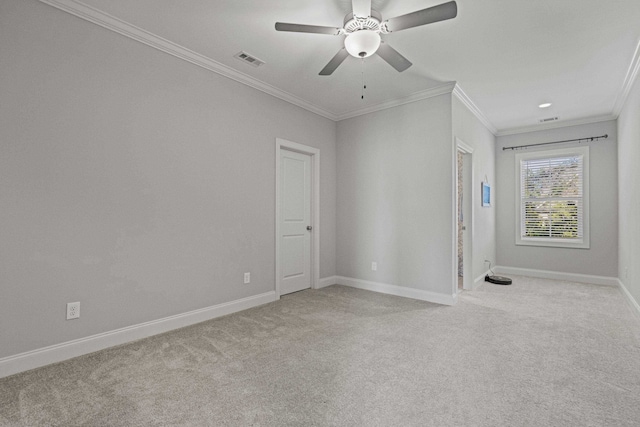 unfurnished room with light carpet, baseboards, visible vents, and ornamental molding