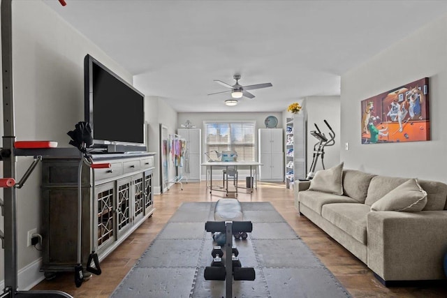 living area with wood finished floors and a ceiling fan