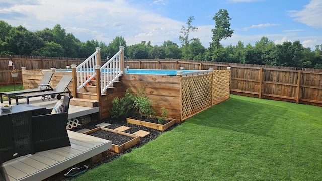 view of yard with a fenced in pool, a vegetable garden, and a fenced backyard