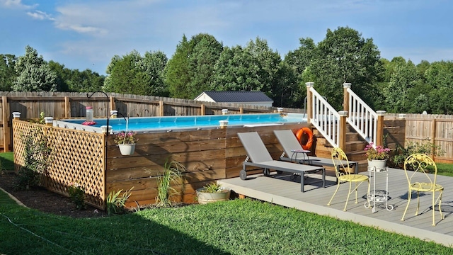 view of pool featuring a fenced backyard, a fenced in pool, and a deck