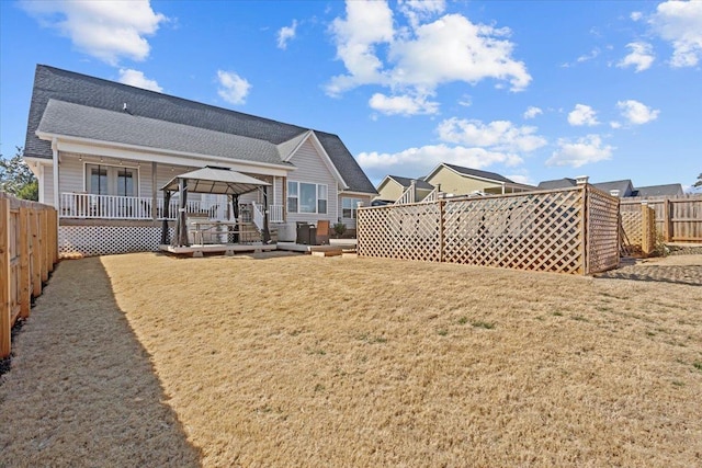 view of yard featuring a gazebo, a fenced backyard, and a wooden deck