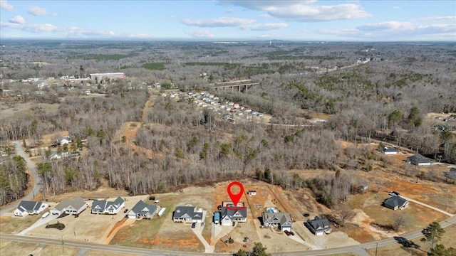 drone / aerial view featuring a wooded view