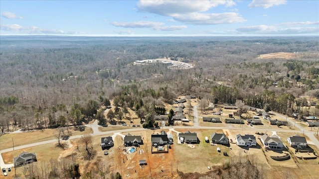 bird's eye view with a wooded view