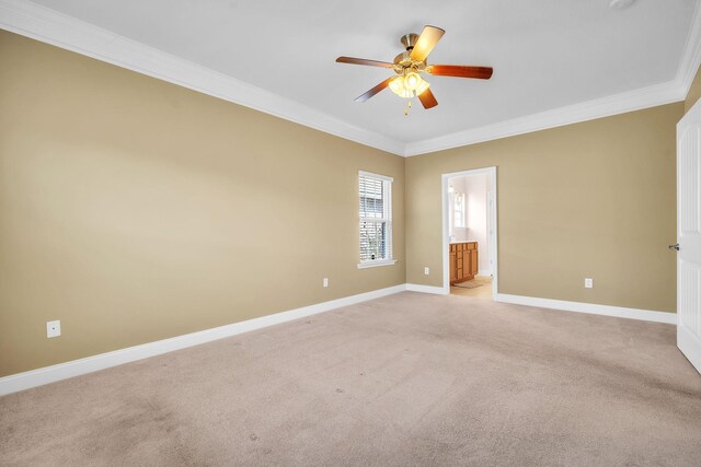 unfurnished room with a ceiling fan, crown molding, light colored carpet, and baseboards