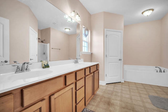 bathroom featuring tile patterned floors, a stall shower, a bath, and a sink