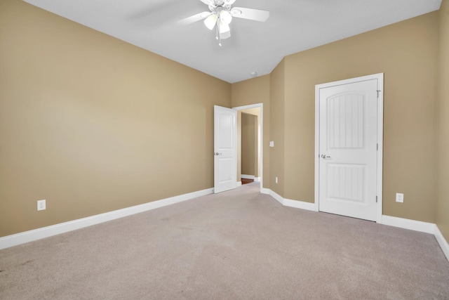 unfurnished bedroom with a ceiling fan, carpet, and baseboards