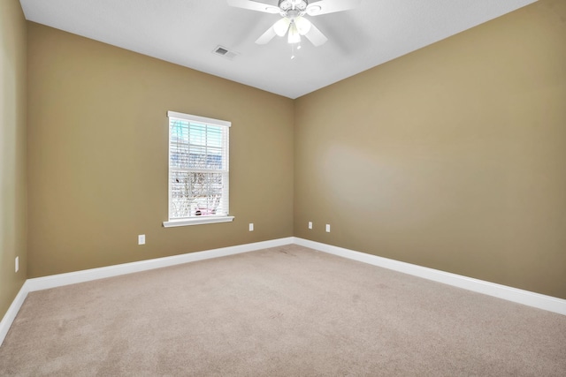 spare room featuring visible vents, baseboards, carpet, and a ceiling fan