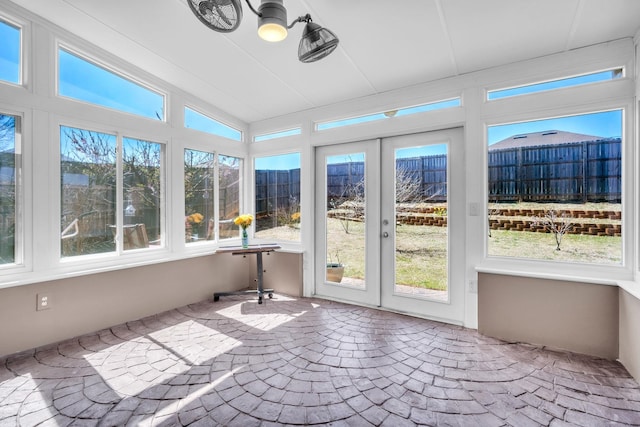 unfurnished sunroom featuring lofted ceiling