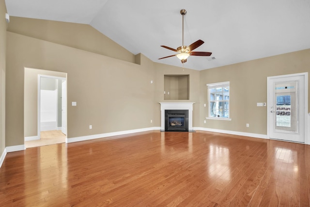 unfurnished living room featuring visible vents, baseboards, ceiling fan, a fireplace with flush hearth, and light wood-style flooring