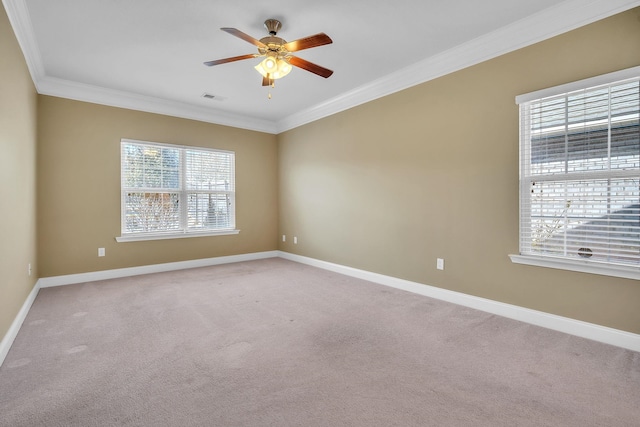 empty room featuring visible vents, crown molding, baseboards, ceiling fan, and light colored carpet