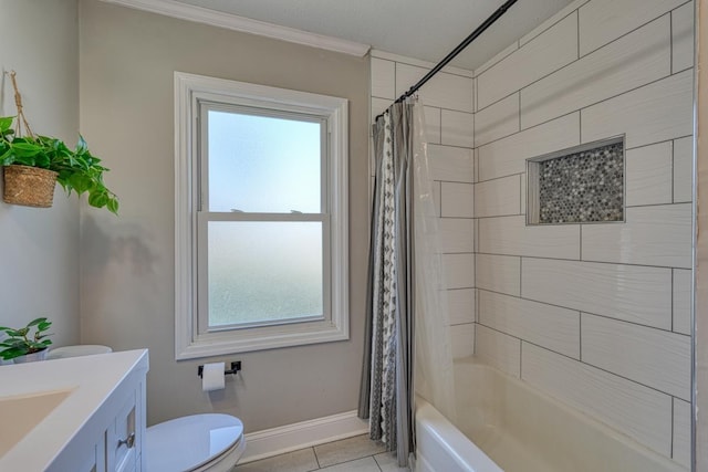 bathroom with tile patterned flooring, crown molding, baseboards, toilet, and vanity