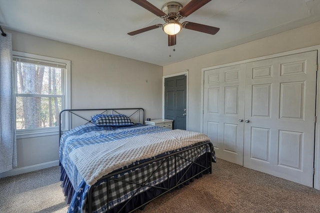 bedroom with a closet, a ceiling fan, baseboards, and carpet floors