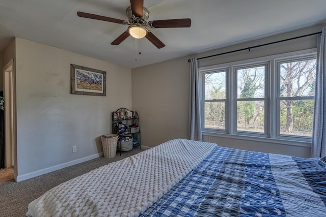 carpeted bedroom with ceiling fan and baseboards