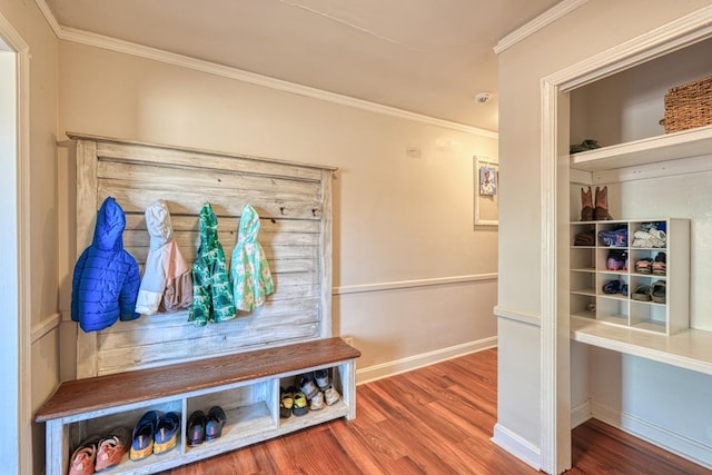 mudroom with baseboards, wood finished floors, and crown molding