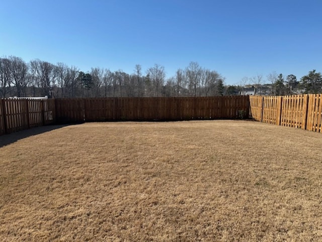 view of yard with a fenced backyard