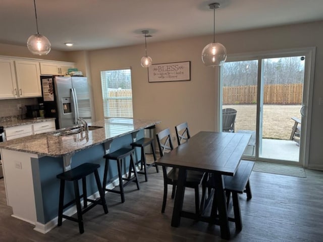 dining space with dark wood finished floors