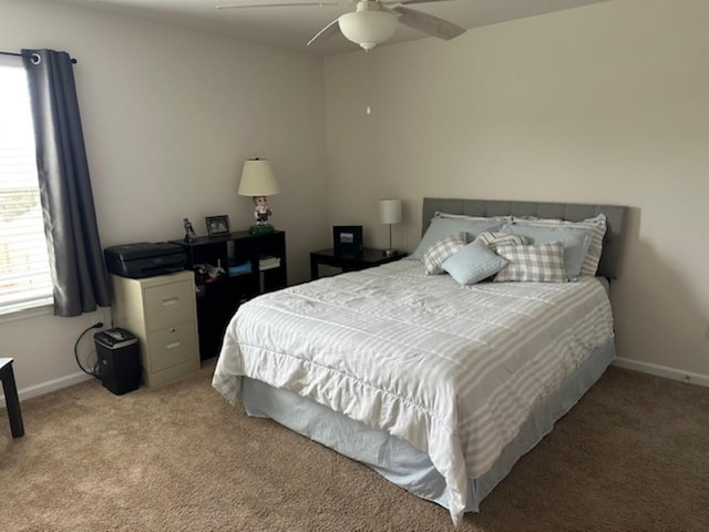 bedroom featuring baseboards, carpet floors, and a ceiling fan